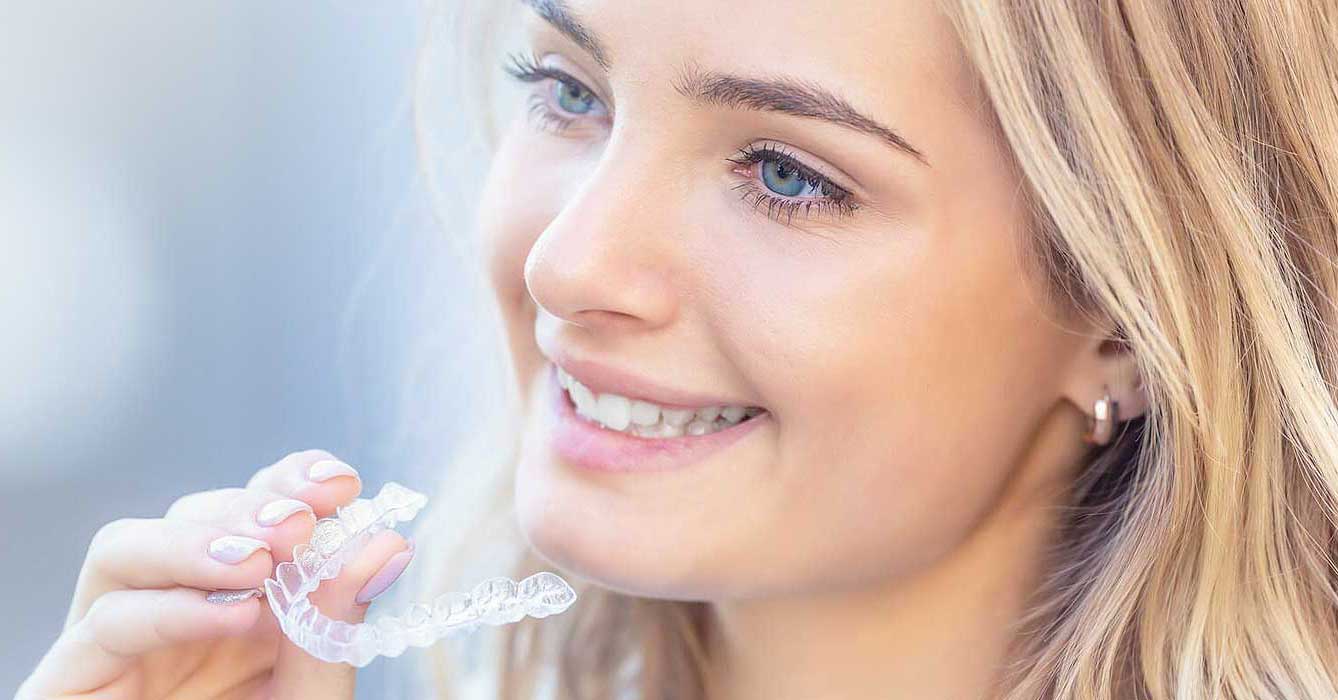 Stock Image of Model Holding Teeth Clip and Smiling