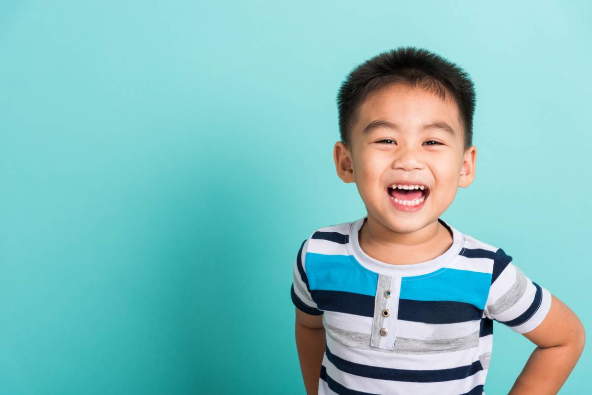 Child smiling on blue background