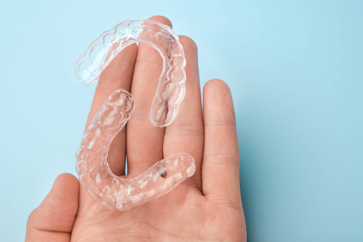 hand holding invisalign braces for treatment