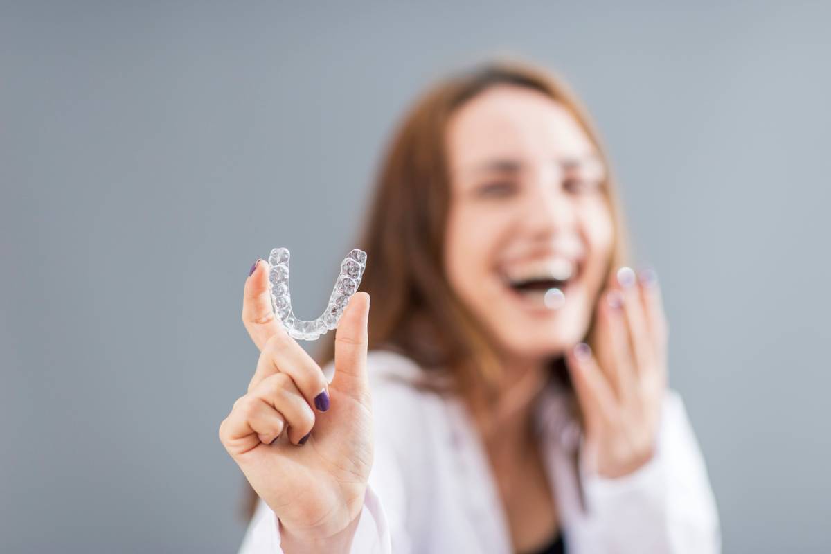 concept image of girl with Invisalign as an adult